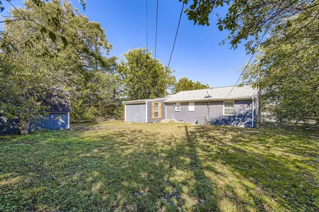 a view of a house with a small yard