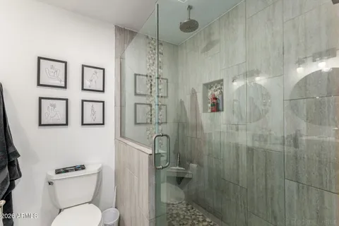 a white toilet sitting next to a bathroom sink