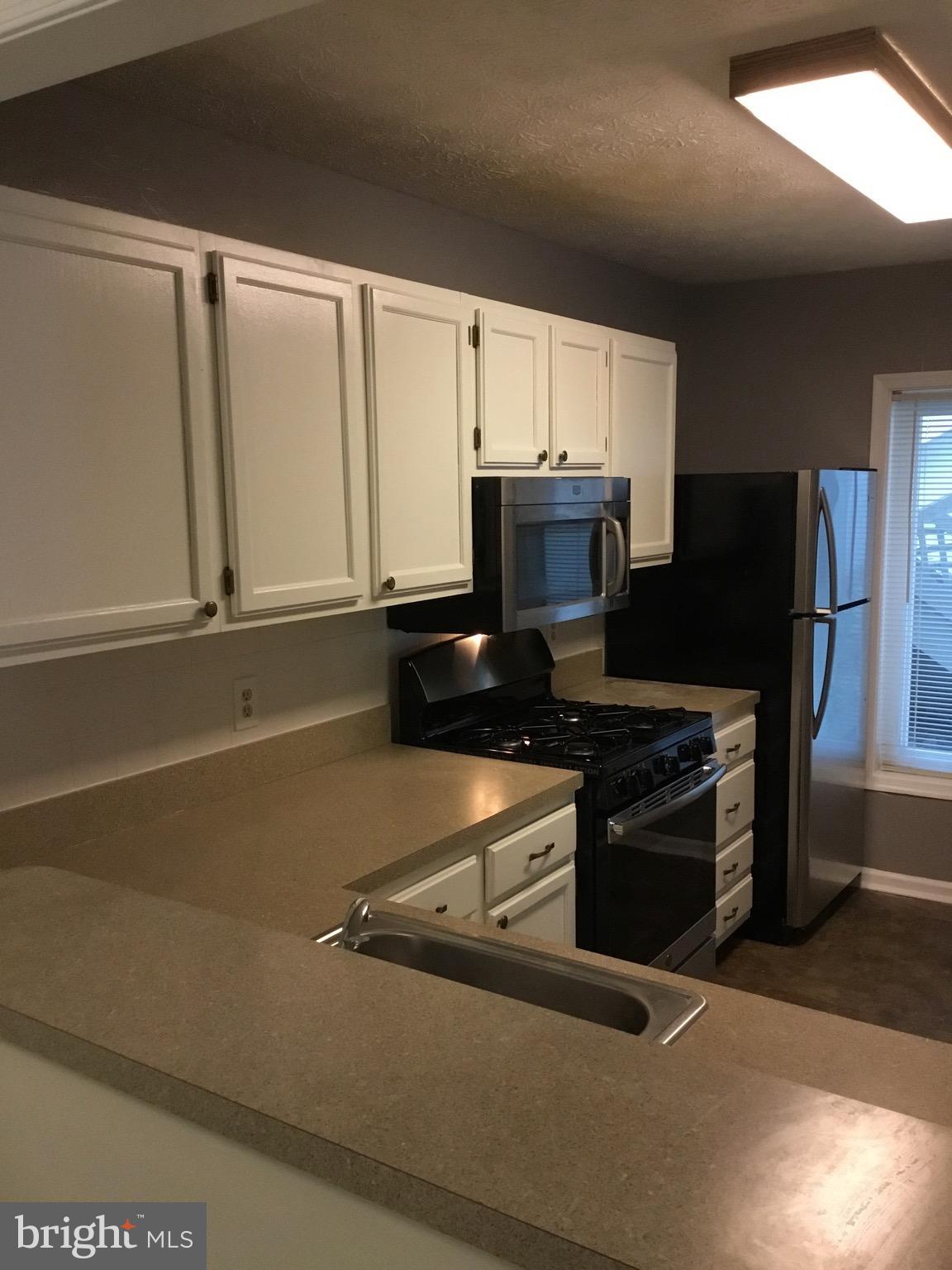 2215 Hunter's Run Drive, Unit 2215 Reston, VA 20191 - Photo 6 of 26 Kitchen Passthrough to Dining Room