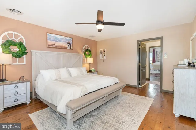 a bedroom with a large bed and a dresser