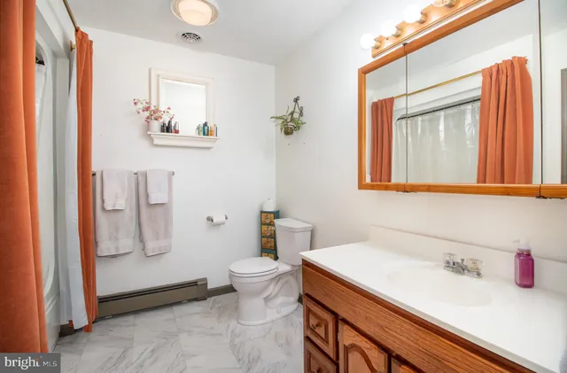 a bedroom with furniture a chandelier fan and a window