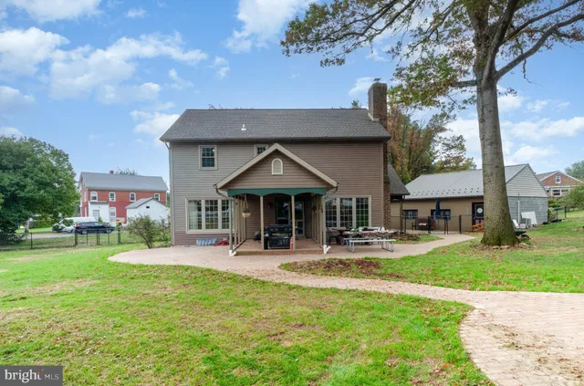 a view of a house with a yard porch and sitting area