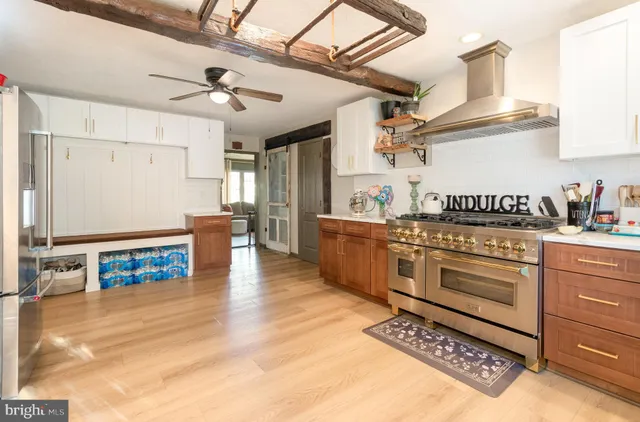 a hallway with wooden floor windows and entryway