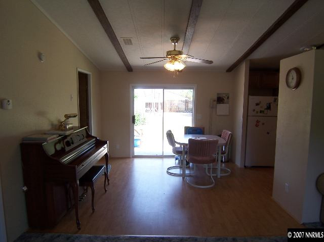 17685 Fantail Street Reno, NV 89508 - Photo 3 of 9 a dining room with furniture a chandelier and wooden floor