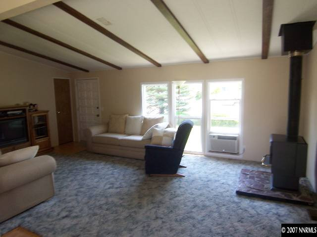 17685 Fantail Street Reno, NV 89508 - Photo 4 of 9 a living room with furniture and a flat screen tv