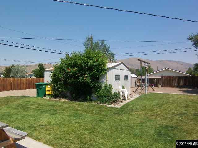 17685 Fantail Street Reno, NV 89508 - Photo 7 of 9 a view of a house with a big yard potted plants and a large tree