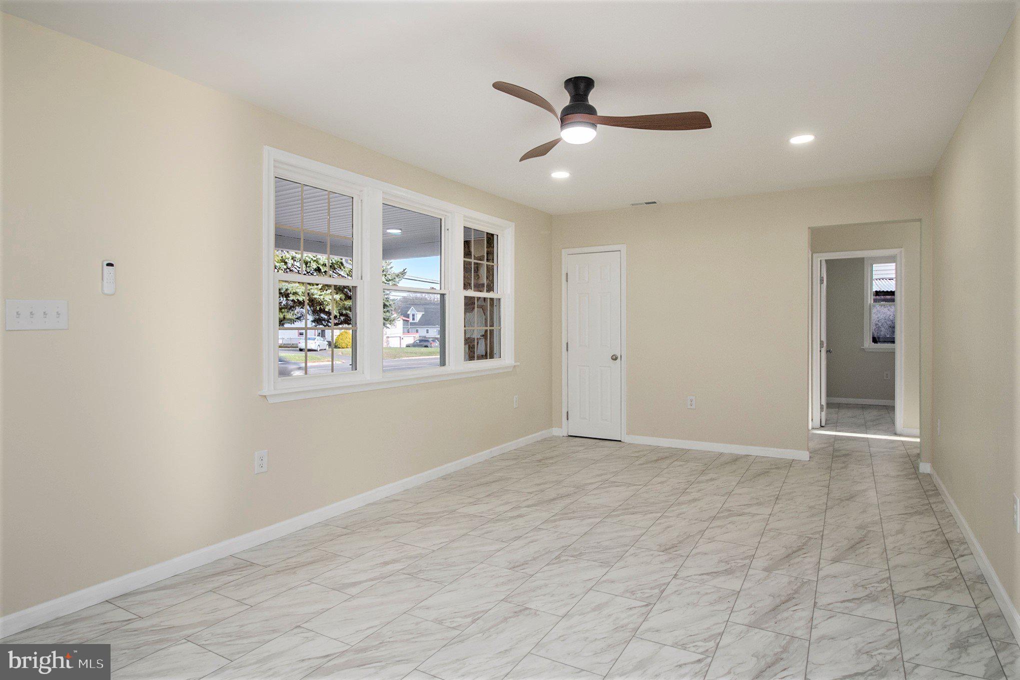 711 West County Line Road Hatboro, PA 19040 - Photo 12 of 40 an empty room with windows and ceiling fan