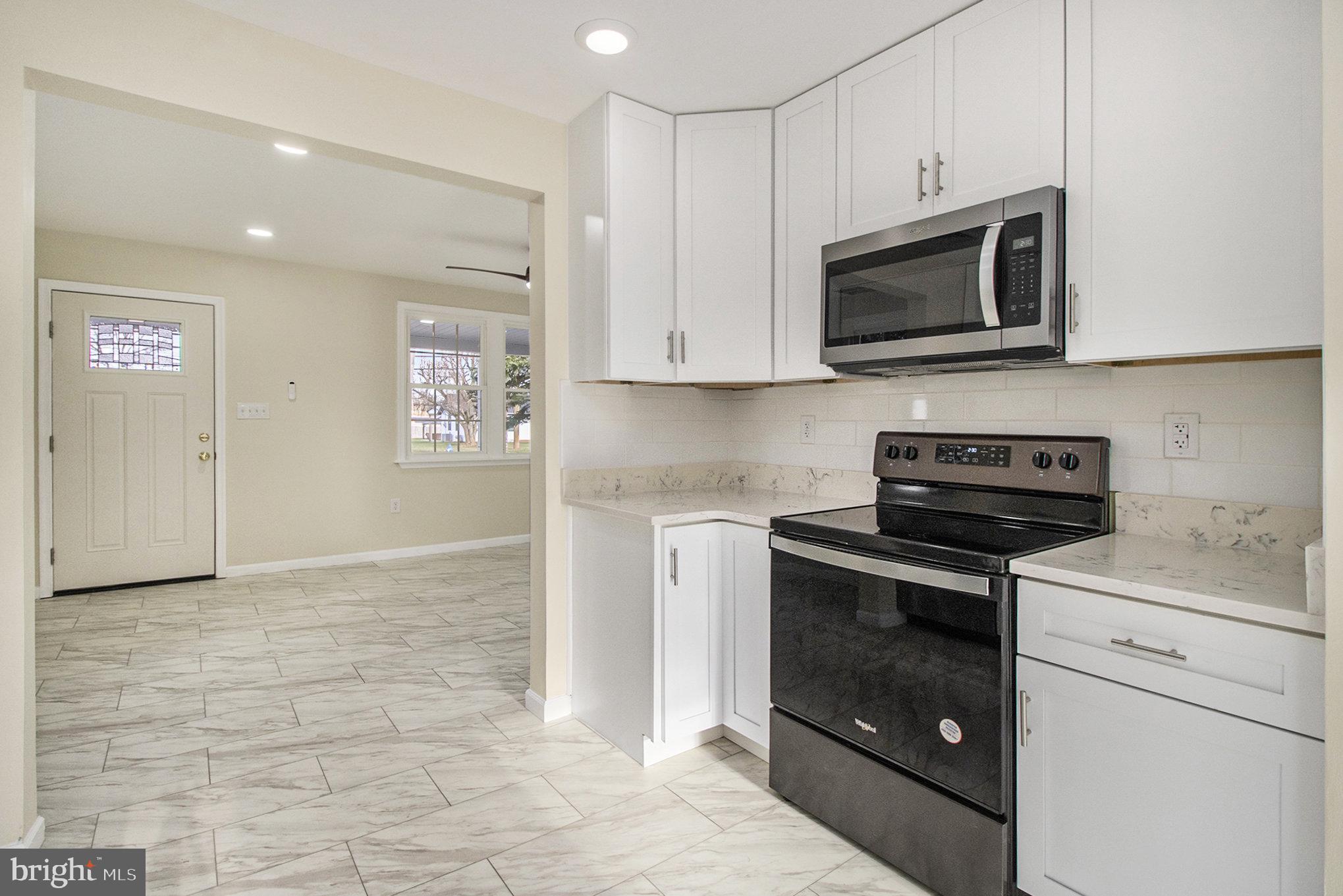 711 West County Line Road Hatboro, PA 19040 - Photo 14 of 40 a kitchen with a stove and a microwave