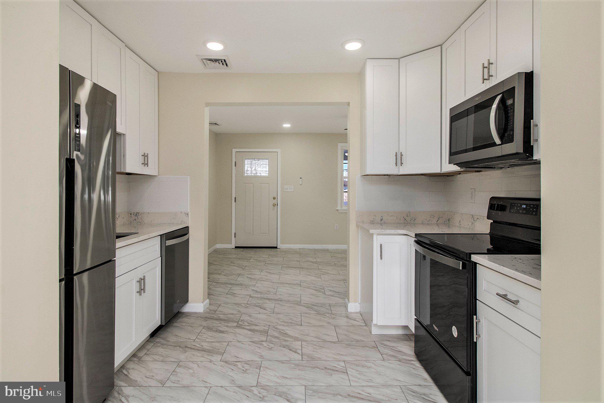 711 West County Line Road Hatboro, PA 19040 - Photo 17 of 40 a kitchen with stainless steel appliances granite countertop a refrigerator and a stove top oven