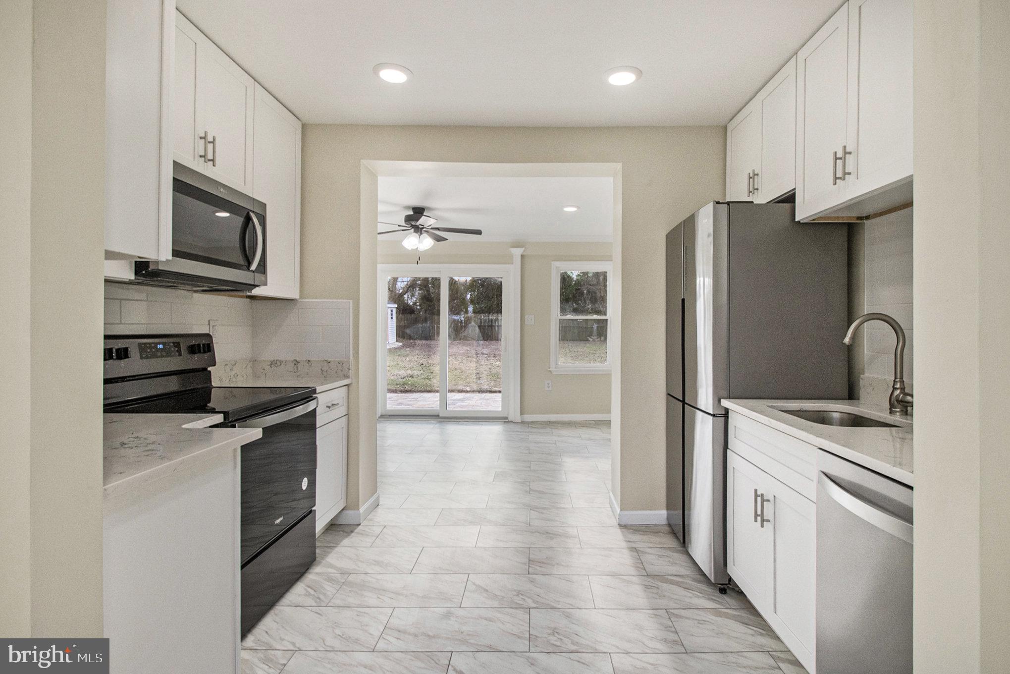 711 West County Line Road Hatboro, PA 19040 - Photo 18 of 40 a kitchen with stainless steel appliances granite countertop a refrigerator a stove top oven a sink and dishwasher