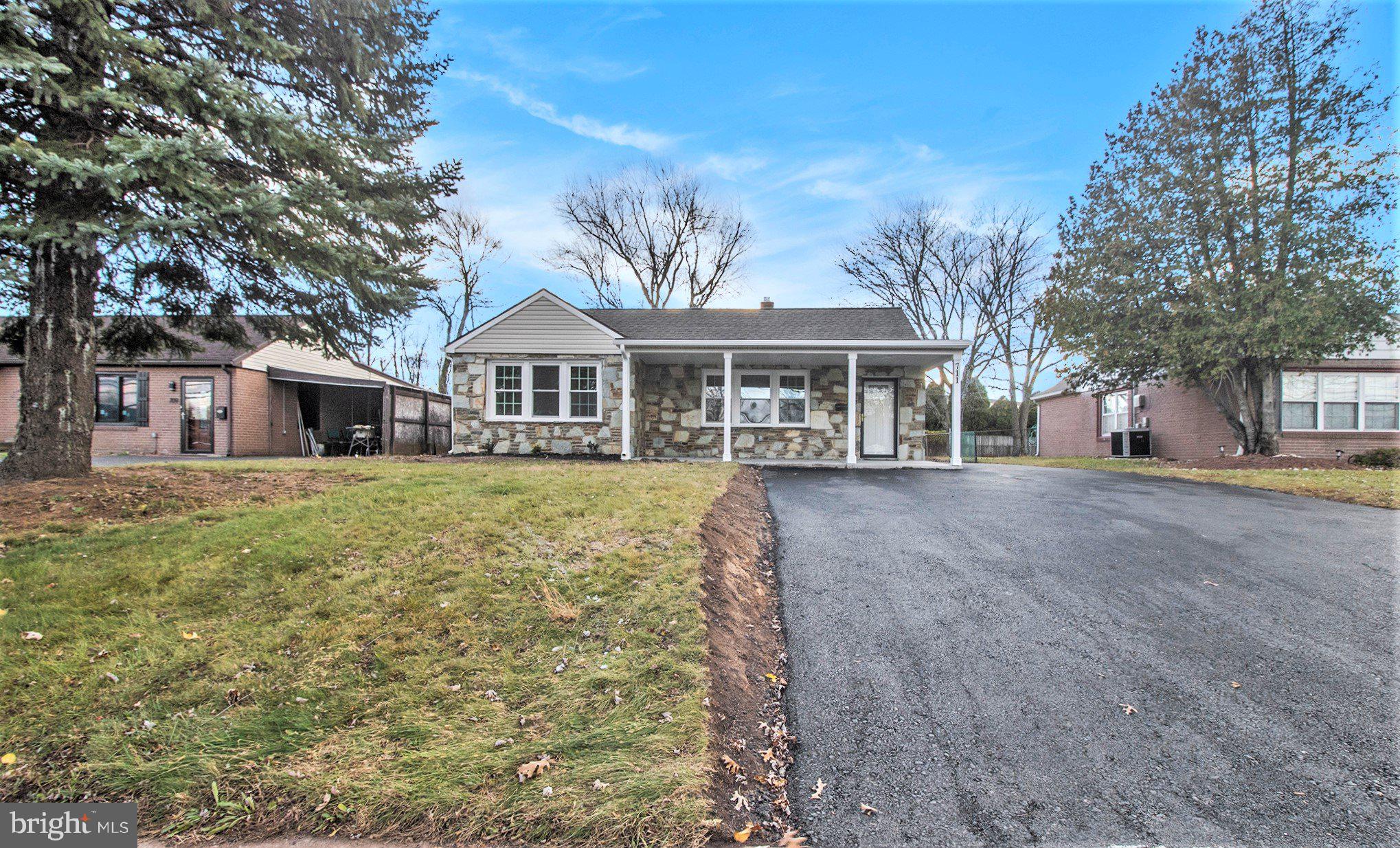 711 West County Line Road Hatboro, PA 19040 - Photo 2 of 40 a front view of a house with a garden