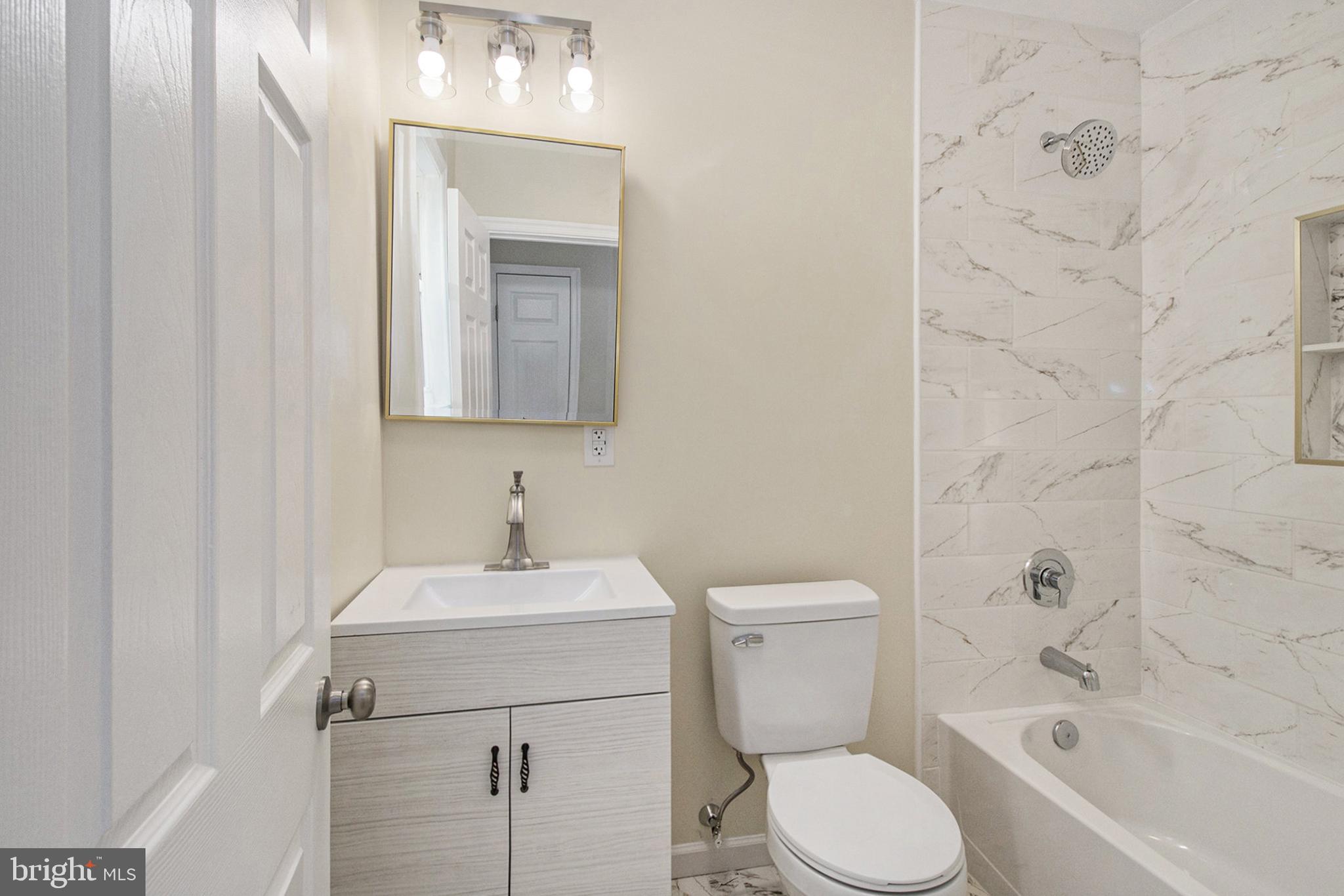 711 West County Line Road Hatboro, PA 19040 - Photo 31 of 40 a bathroom with a toilet sink and mirror