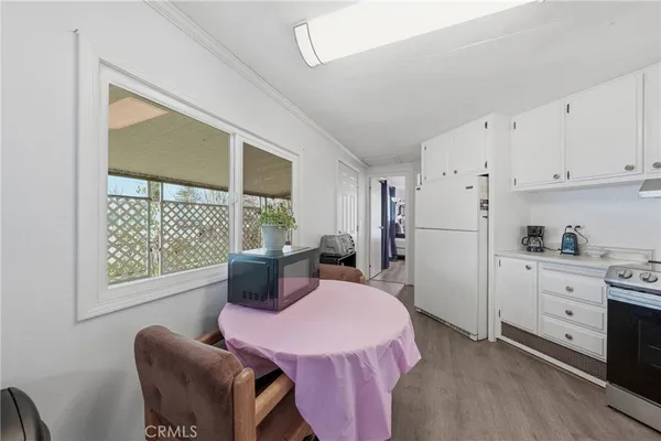 a kitchen with a table chairs stove and cabinets