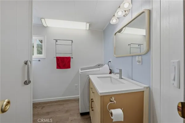 a bathroom with a bathtub a shower and a window