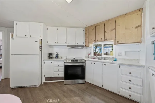 a kitchen with cabinets appliances and a sink