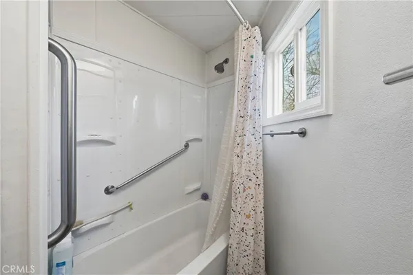 a view of a room with wooden floor and window