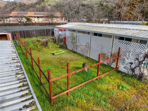 a view of a backyard with sitting area