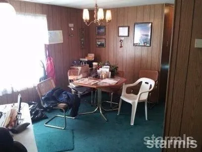 a dining room with furniture and a chandelier