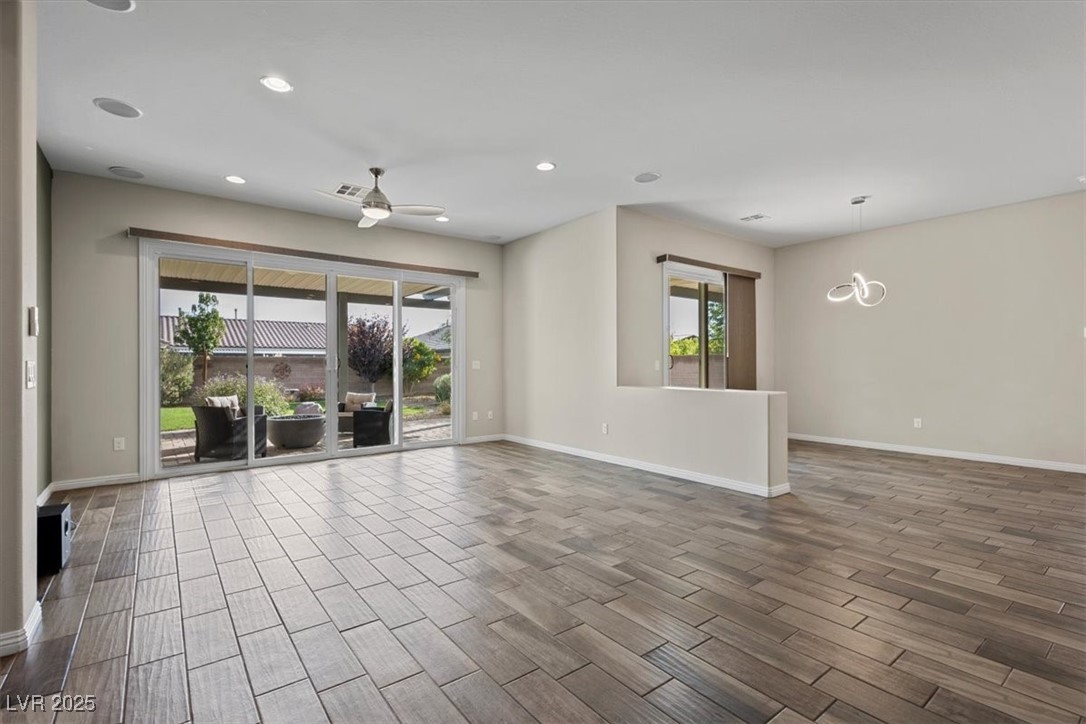 7072 Arabian Ridge Street Las Vegas, NV 89131 - Photo 3 of 30 living room with Full length sliding glass patio, surruond sound doors, dining room to the right