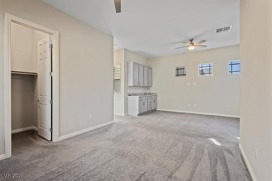 7072 Arabian Ridge Street Las Vegas, NV 89131 - Photo 7 of 30 Next Gen Suite with walk in closet, private bathroom, granite counters, cabinets, sink