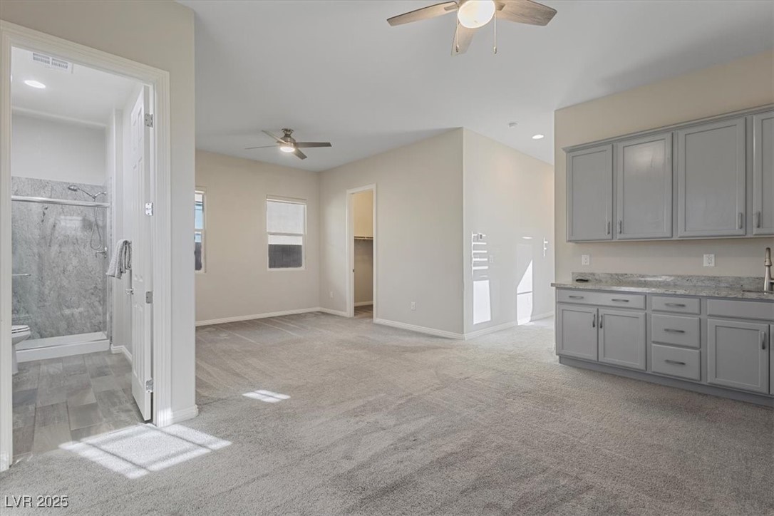 7072 Arabian Ridge Street Las Vegas, NV 89131 - Photo 8 of 30 Next Gen Suite with walk in closet, private bathroom, granite counters, cabinets, sink