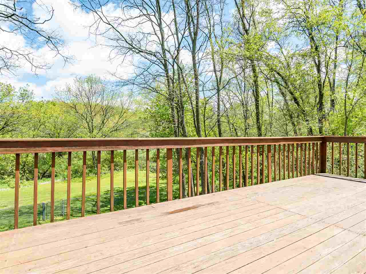 10201 North Campbell Road Durand, IL 61024 - Photo 11 of 20 a view of balcony with wooden floor and fence