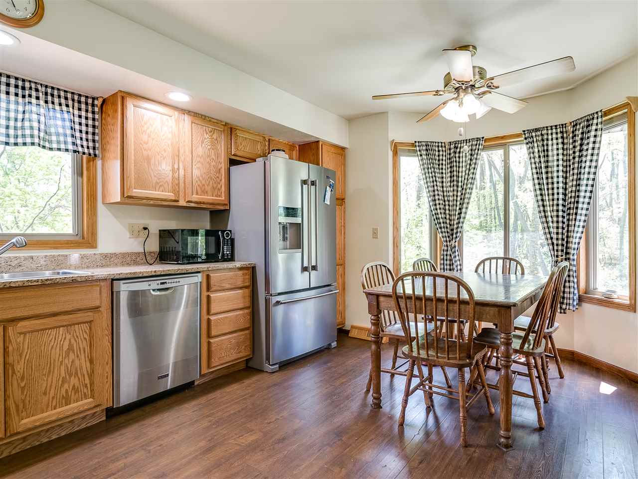 10201 North Campbell Road Durand, IL 61024 - Photo 16 of 20 a kitchen with stainless steel appliances granite countertop a kitchen island hardwood floor sink stove and dining table