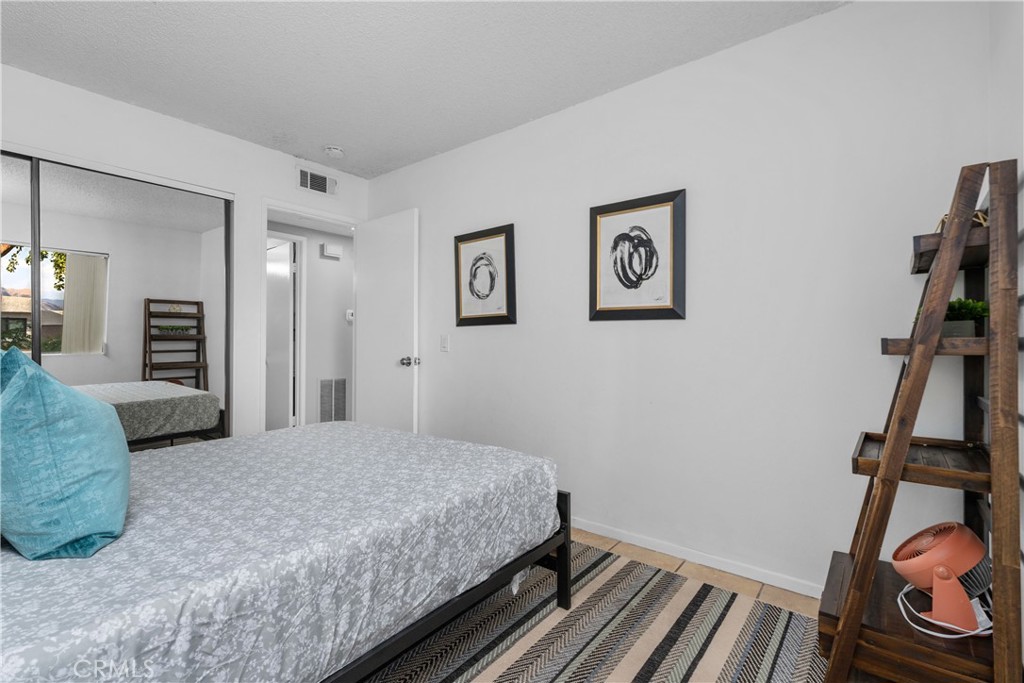 69646 Antonia Way Rancho Mirage, CA 92270 - Photo 31 of 50 a bedroom with a bed and a flat screen tv
