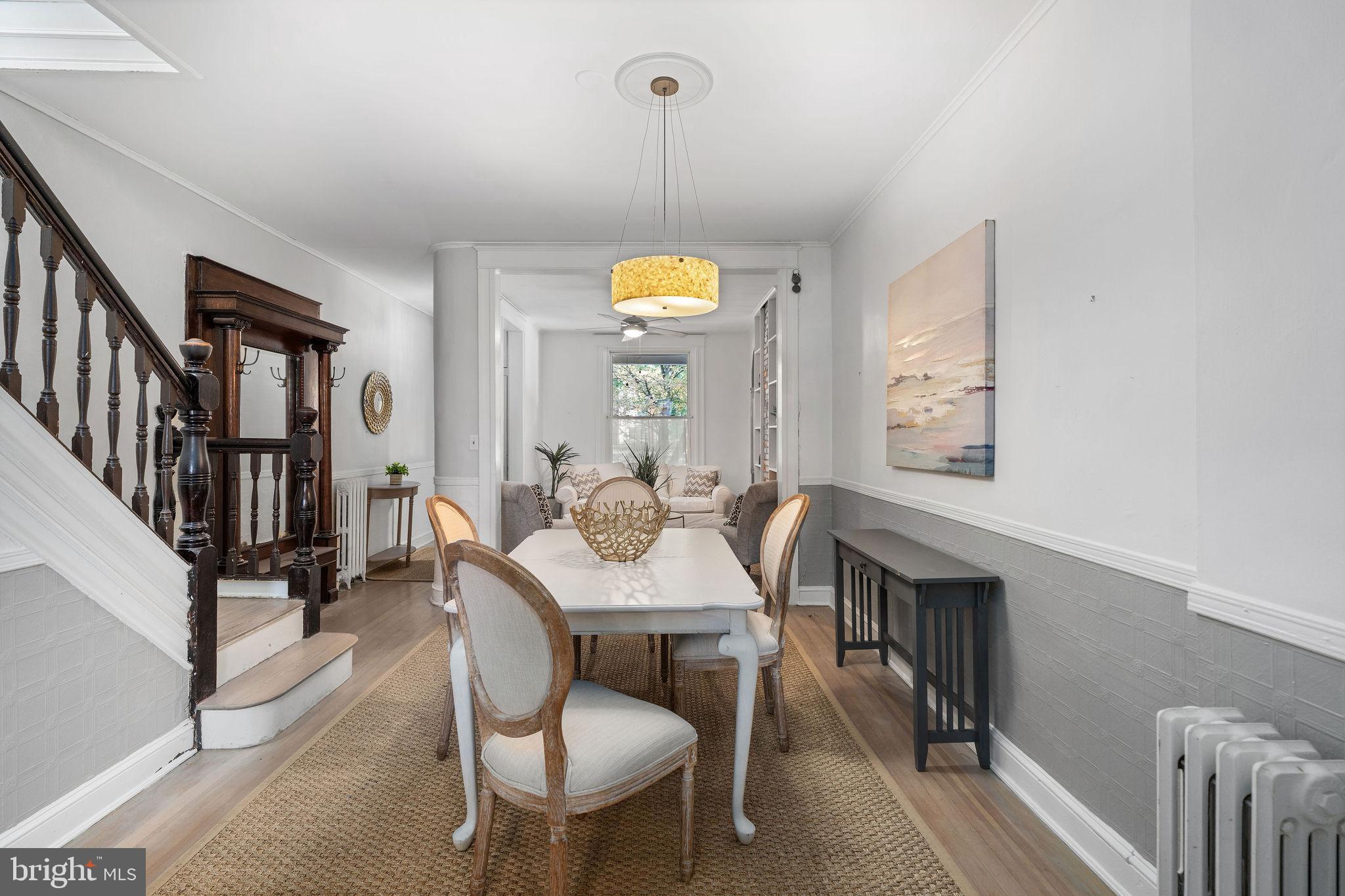 4148 Falls Road Baltimore, MD 21211 - Photo 11 of 37 a view of a dining room with furniture window and wooden floor