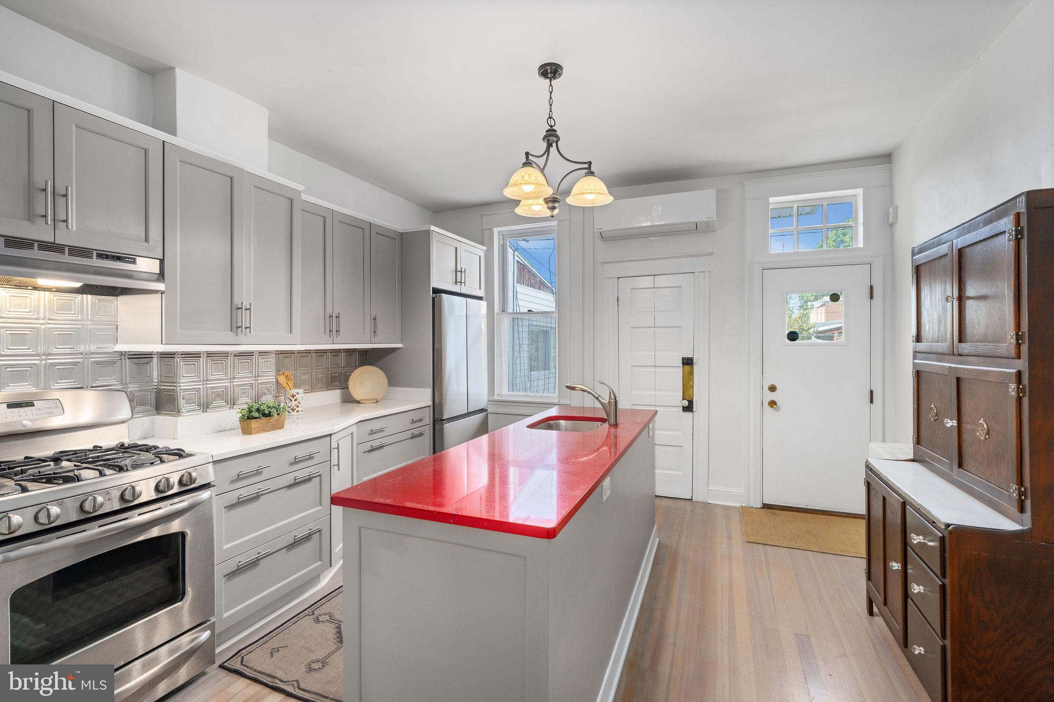 4148 Falls Road Baltimore, MD 21211 - Photo 13 of 37 a kitchen with a stove a sink and a refrigerator