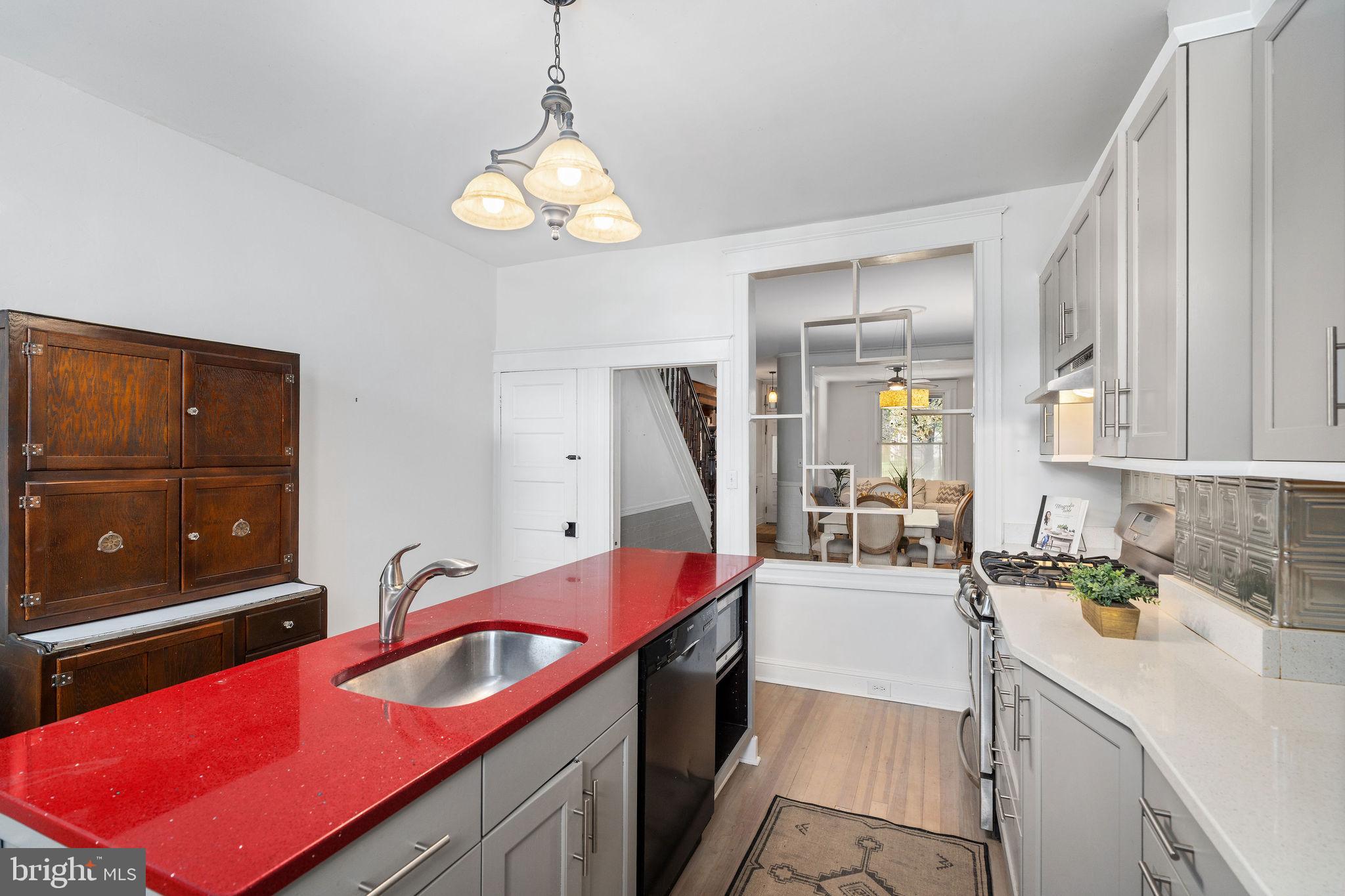 4148 Falls Road Baltimore, MD 21211 - Photo 16 of 37 a kitchen that has a lot of cabinets a sink and a stove