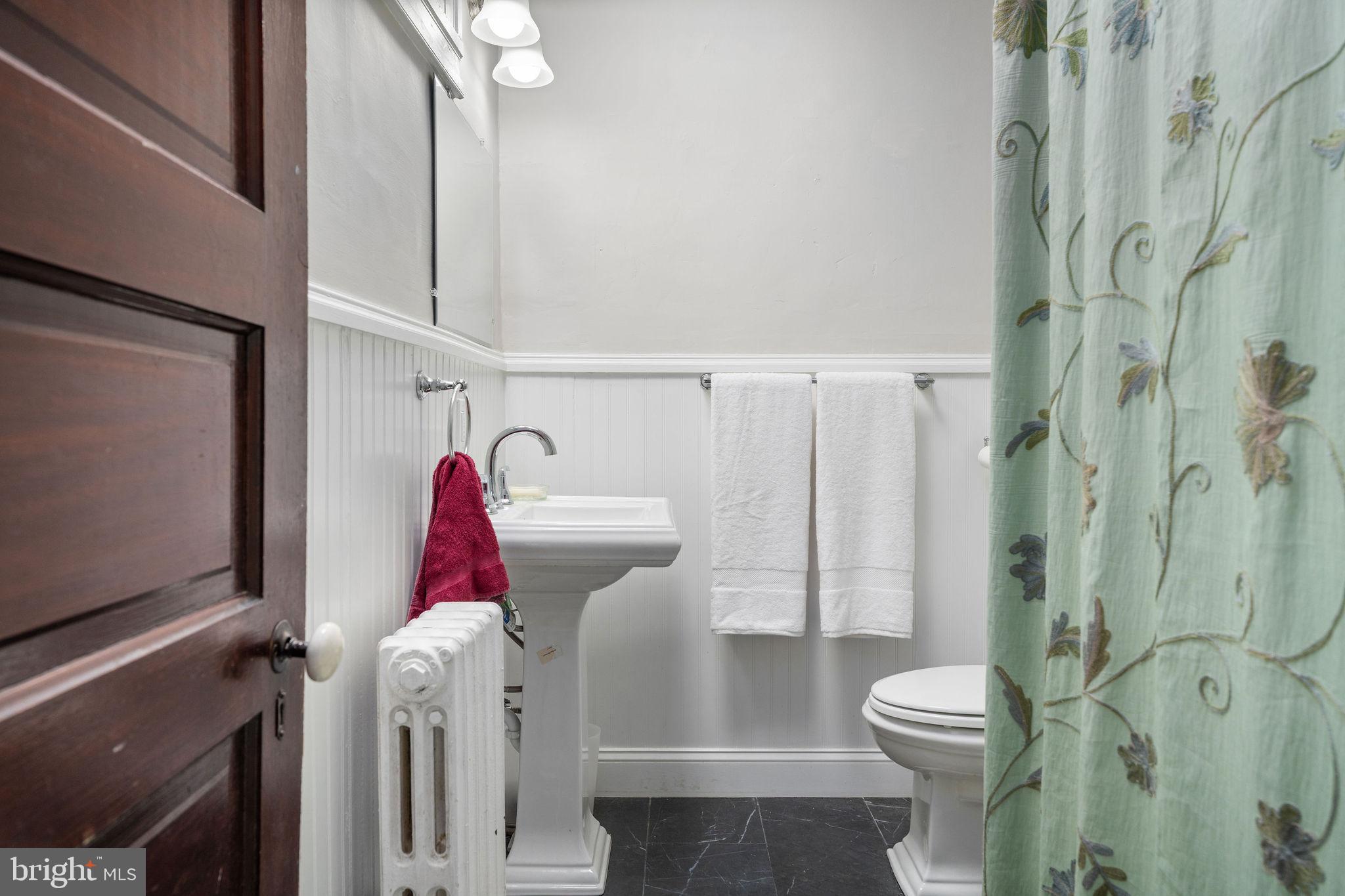 4148 Falls Road Baltimore, MD 21211 - Photo 19 of 37 a bathroom with a toilet sink and shower