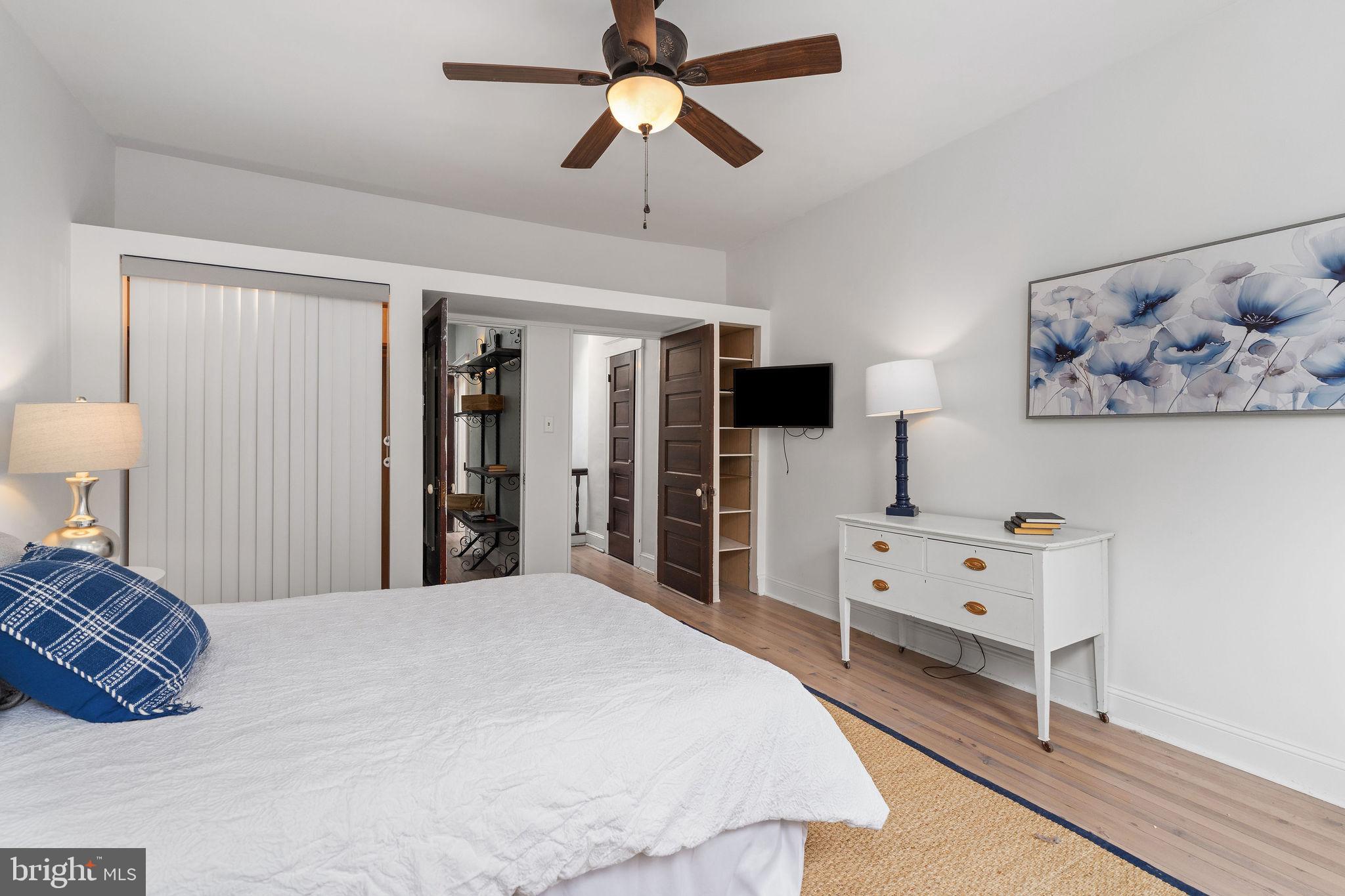 4148 Falls Road Baltimore, MD 21211 - Photo 21 of 37 a bed room with a bed and a chandelier