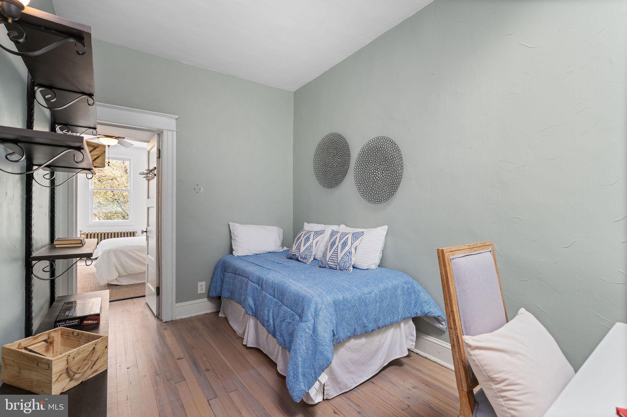 4148 Falls Road Baltimore, MD 21211 - Photo 23 of 37 a bedroom with a bed and wooden floor