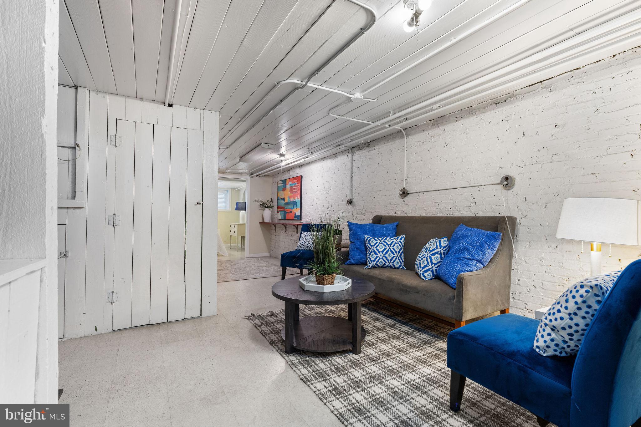 4148 Falls Road Baltimore, MD 21211 - Photo 26 of 37 a living room with furniture and a fireplace