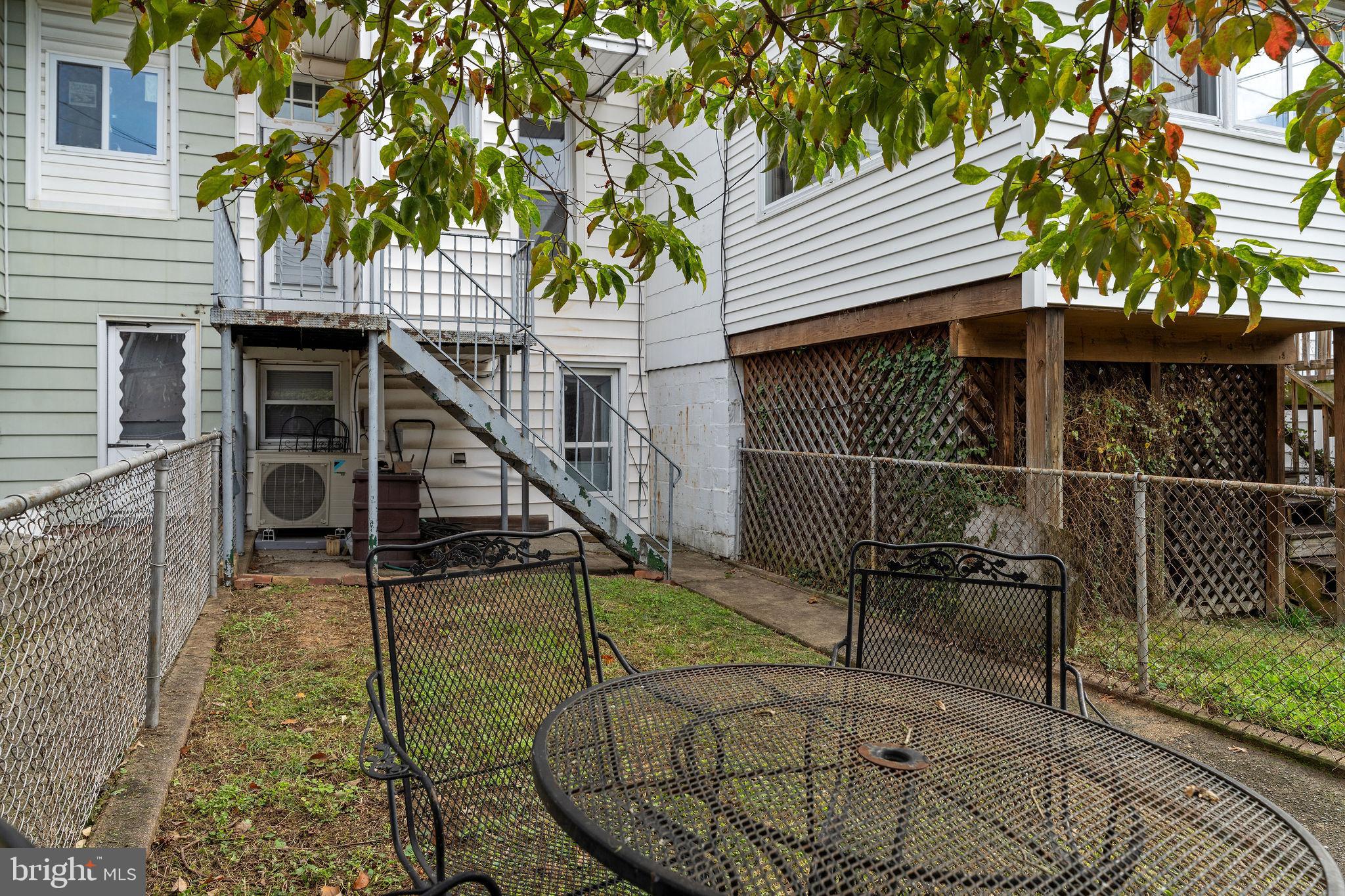 4148 Falls Road Baltimore, MD 21211 - Photo 35 of 37 a view of house with wooden deck and furniture