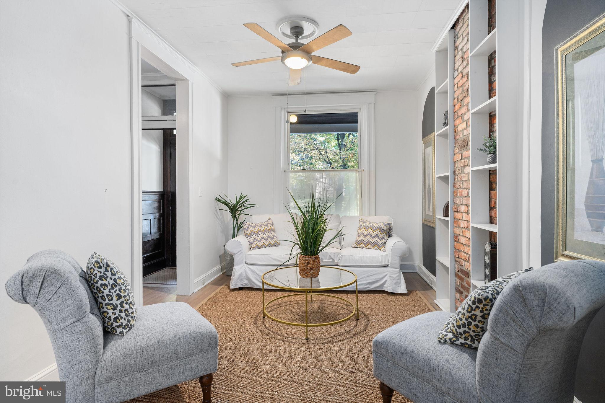 4148 Falls Road Baltimore, MD 21211 - Photo 6 of 37 a living room with furniture and a large window