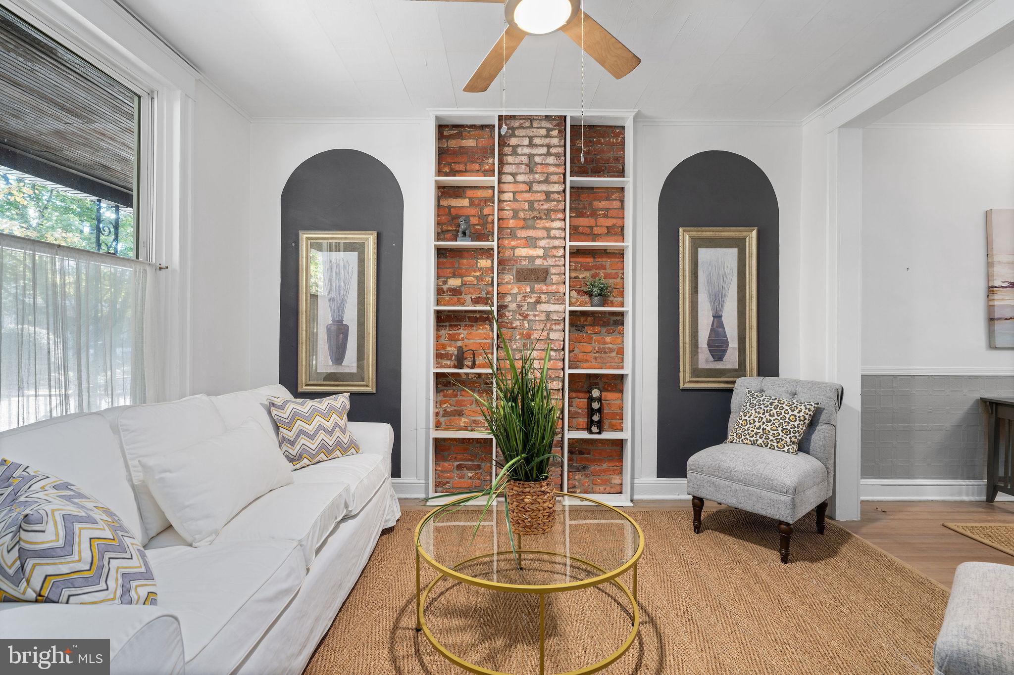 4148 Falls Road Baltimore, MD 21211 - Photo 7 of 37 a living room with furniture and a large window