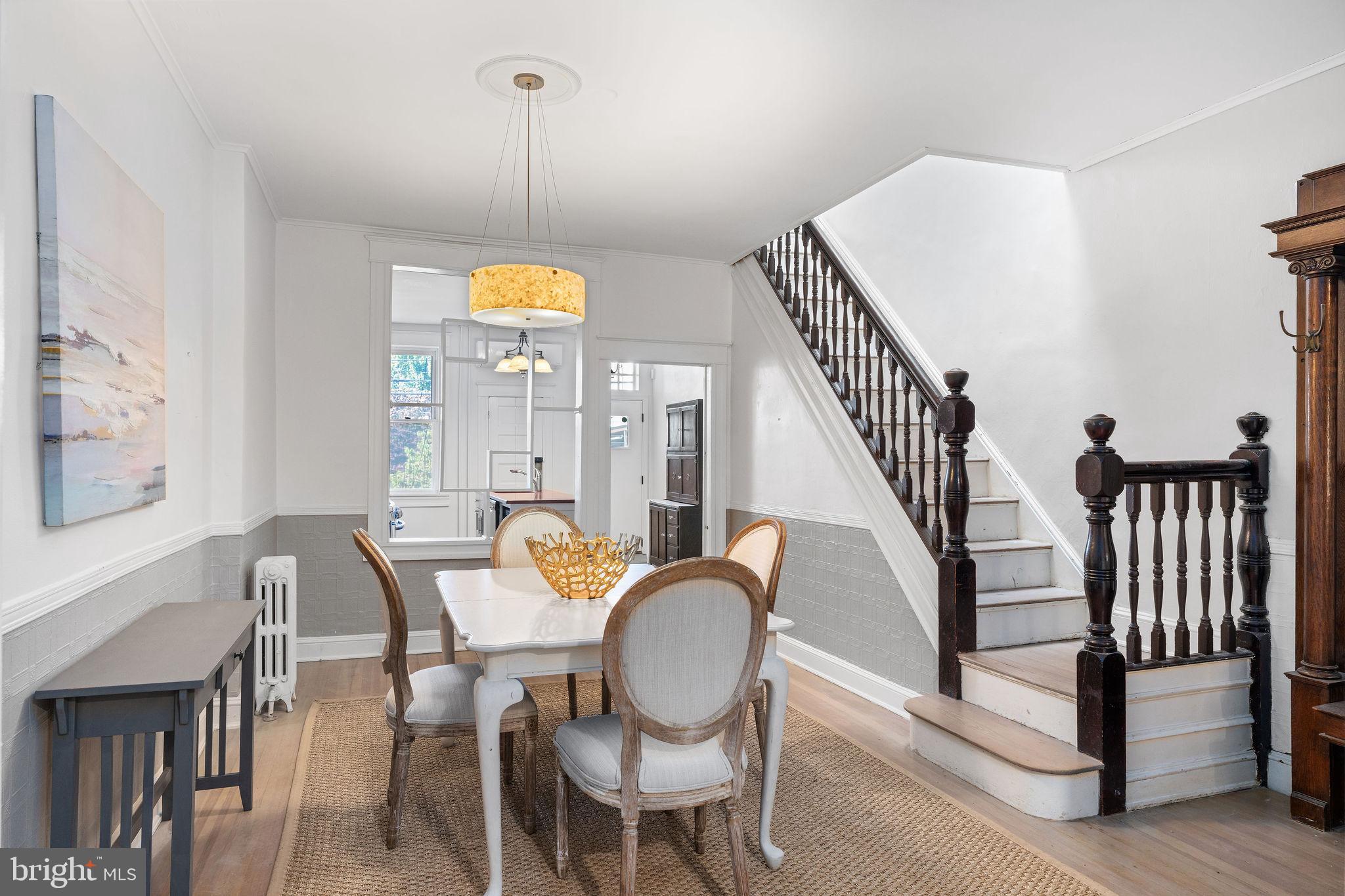 4148 Falls Road Baltimore, MD 21211 - Photo 9 of 37 a dining room with furniture a chandelier and wooden floor