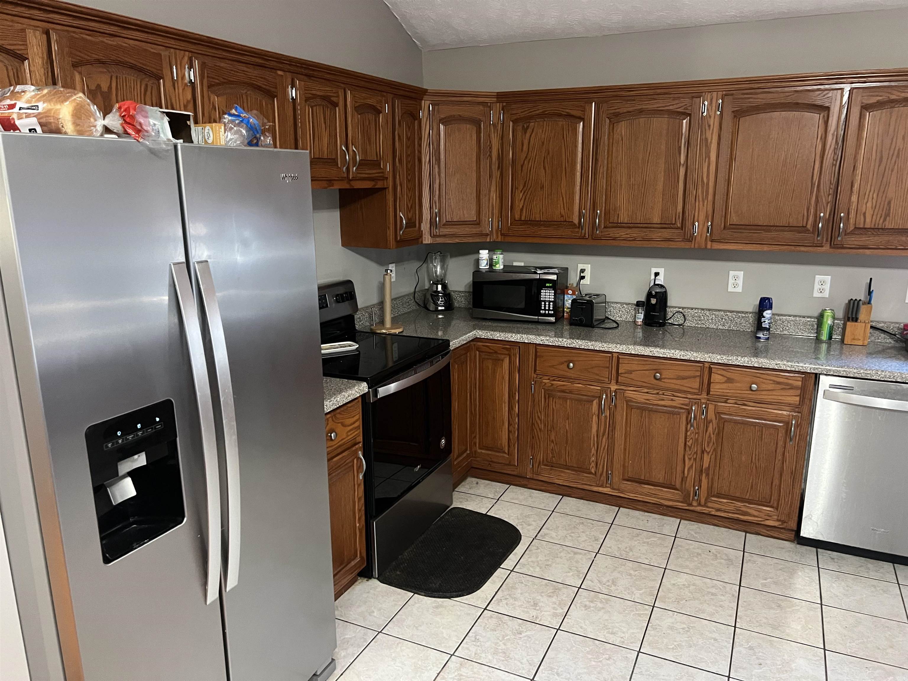 245 Drake Loop Savannah, TN 38372 - Photo 2 of 17 a kitchen with stainless steel appliances granite countertop a refrigerator sink and cabinets