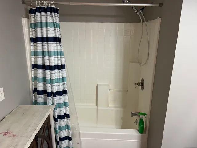a bathroom with a bathtub and a shower