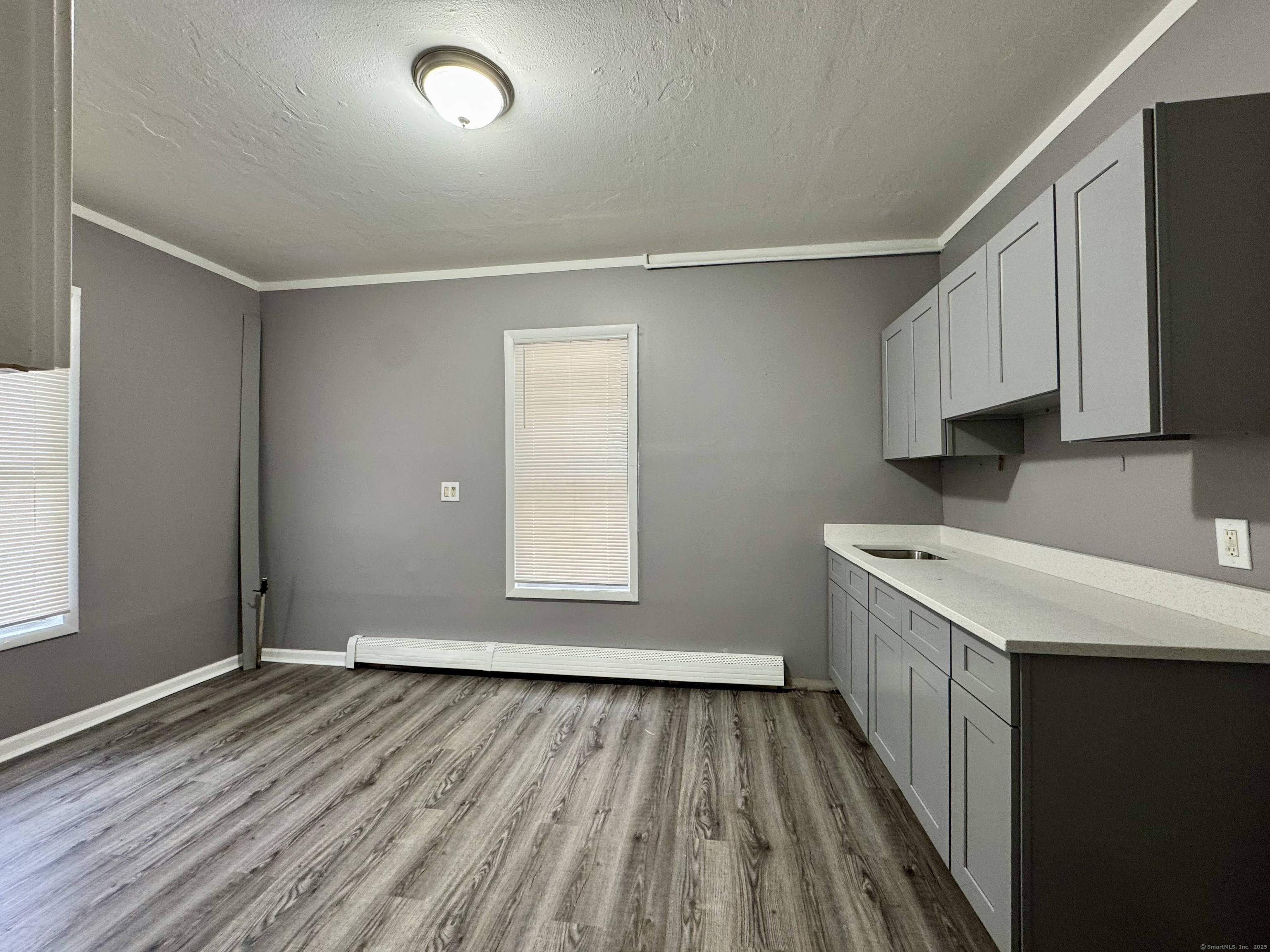 1102 East Main Street, Unit 1 Bridgeport, CT 06608 - Photo 4 of 14 wooden floor in an empty room with a window
