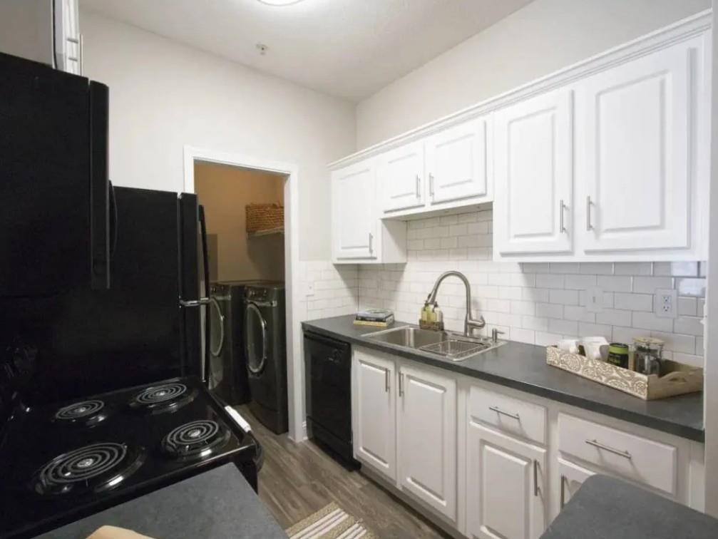 100 Crossing Boulevard, Unit 1301 McDonough, GA 30253 - Photo 1 of 26 a kitchen with sink refrigerator and cabinets
