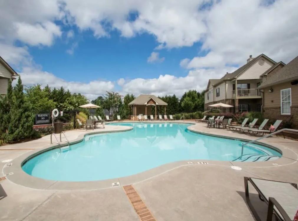 100 Crossing Boulevard, Unit 1301 McDonough, GA 30253 - Photo 24 of 26 a view of a swimming pool and lounge chairs