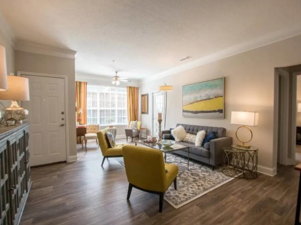 100 Crossing Boulevard, Unit 1301 McDonough, GA 30253 - Photo 6 of 26 a living room with furniture and a wooden floor