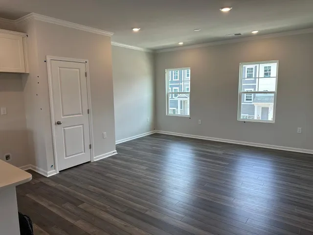 a view of a livingroom with wooden floor and window