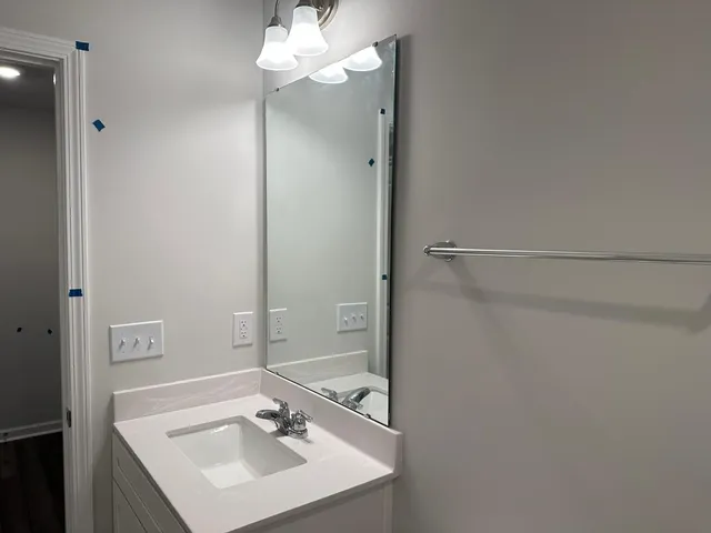 a bathroom with a sink and a mirror