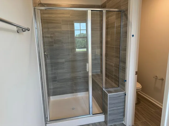 a bathroom with a glass shower door