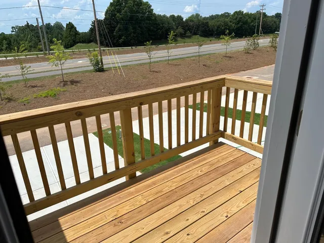a view of balcony with wooden floor