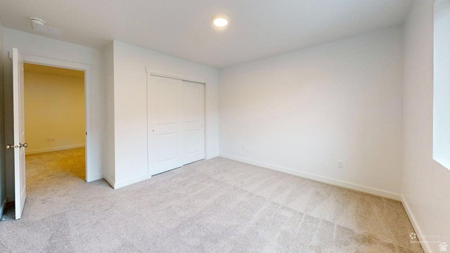 777 Pheasantbrook Drive, Unit 2B Centerville, UT 84014 - Photo 27 of 42 Carpeted room featuring a ceiling-mounted light fixture, white walls, and white trim